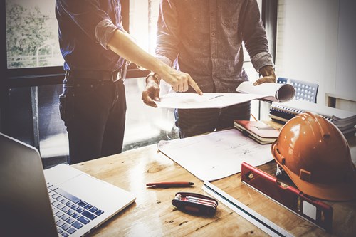 Two Architect man working with compasses and blueprints for architectural plan, sketching a construction engineer project concept