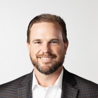 Businessman with beard and mustache wearing a white shirt and checked suit jacket