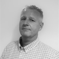 Black and white photo of businessman in a white checked shirt