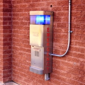 Emergency intercom fixed to a red brick wall