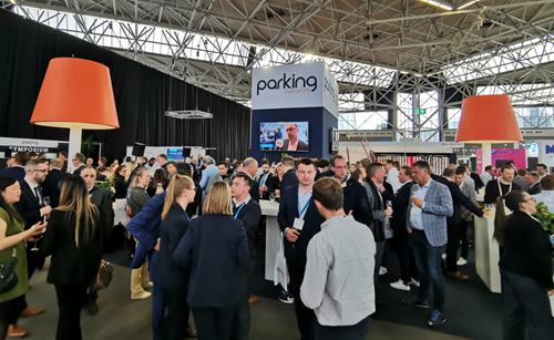 Business men and women gathered at a tradeshow booth