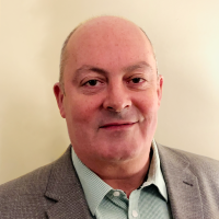 Businessman in a grey suit and green shirt