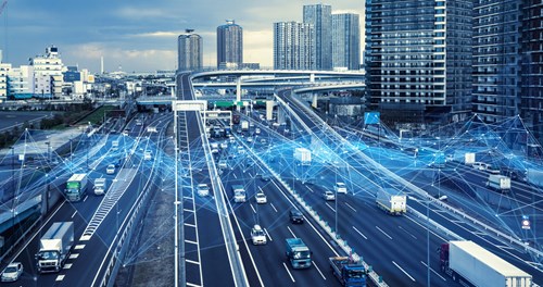 A grayscale image of a city skyline with busy highway intersection