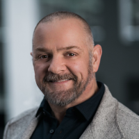 Business man in a black shirt and grey suit jacket