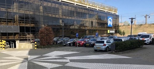 Multistory parking facility with outdoor parking lot