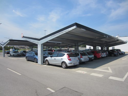 Carport above a row of parked cars.