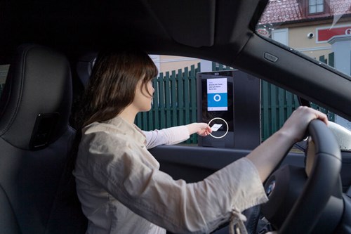 Woman inserting a parking ticket