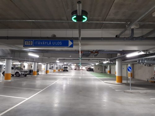 Parking Garage with green and red parking guidance lights hanging from ceiling.