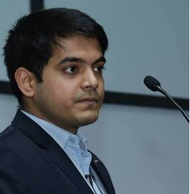 Headshot of business man speaking into microphone