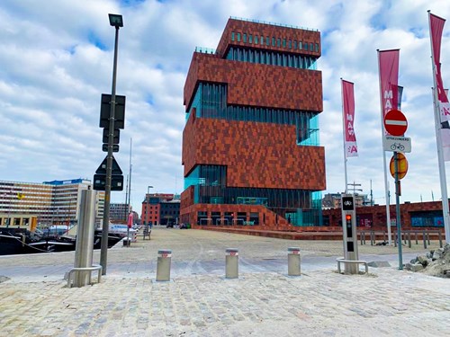 Tall brown and glass building with parking access control