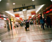 Shopping mall with shops either side of wide corridor