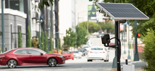 Solar power controlled LPR with red car in the backgroun