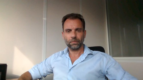 Headshot of Jacques Jouannais, wearing pale blue shirt and sitting at a desk