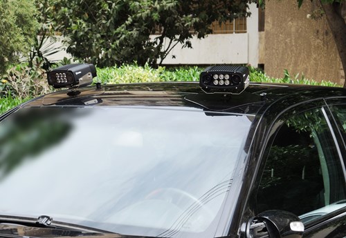 Two LPR enforcement cameras attached to the roof of a black car.