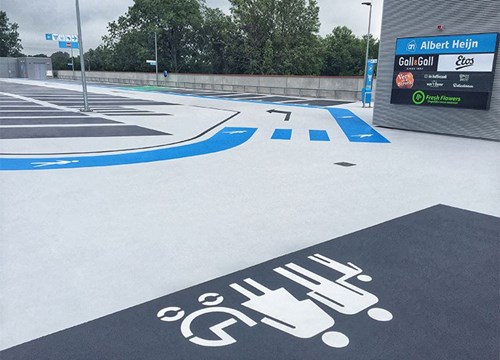 Family parking spaces with directional arrows for cars and pedestrian walkways