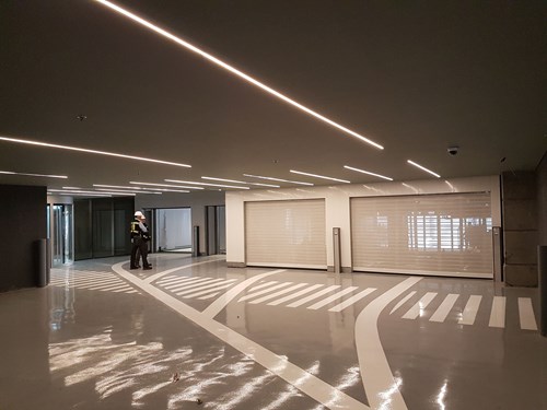 Interior of a car park with gloss parking surface and two garage doors.