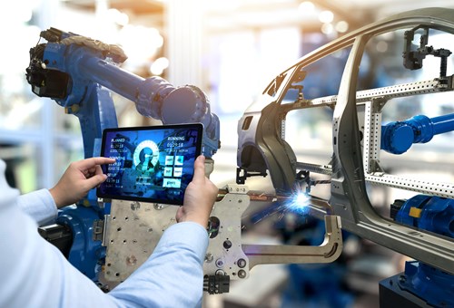 Man holds iPad up to a machine