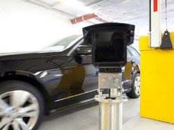 Car driving passed yellow access barrier